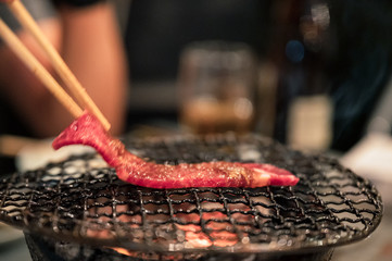 Grilled raw beef slice on flaming grill