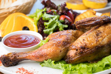 Fried chicken with potatoes and fresh salad on a white plate