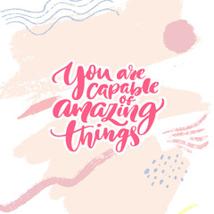 You are capable of amazing things. Inspirational quote calligraphy for planners, journals, posters and clothing. Modern brush lettering, pink text on abstract background
