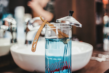 Razor in Barbicide Disinfecting Jar at barber shop
