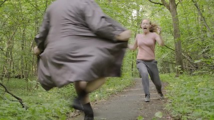 girl makes run along forest path when exhibitionist jumps out in front of her. woman feels fear and runs away from pervert man.