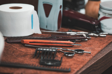 Barber shop tools on old wooden background.Barber vintage tools for beard grooming in retro barber shop