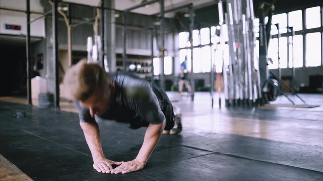 Athletic young man doing diamond push-ups in the gym for wellness, workout, muscular body and healthy life. Caucasian people and sports. Exersize from beginner to advanced without equipment. Explosive