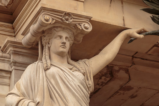 Statue of woman. Marble sculpture female bust. Caryatid stained sculpture adorns the old house facade