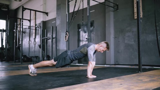 Athletic young man doing diamond push-ups in the gym for wellness, workout, muscular body and healthy life. Caucasian people and sports. Exersize from beginner to advanced without equipment. Explosive