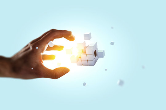 Man`s hand and cubes levitating beside. Mixed media