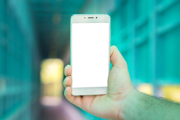 The big white smartphone in a hand close up against the background of a tunnel. Space for the text