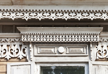 Traditional for Siberian wooden houses carved decorations on the windows. Old wooden architecture of Irkutsk