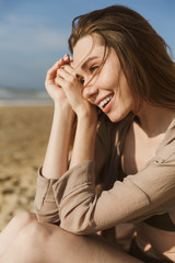 Happy smiling pleased amazing woman posing outdoors at the sea beach.