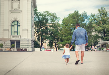 Father walking with his daughter