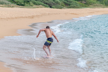 Fototapeta premium young guy on the board on the waves