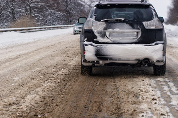 Cars with winter tires on snow-covered road
