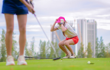 young woman golf player acting upset disaster or disturb or disappointed in golf ball putting...