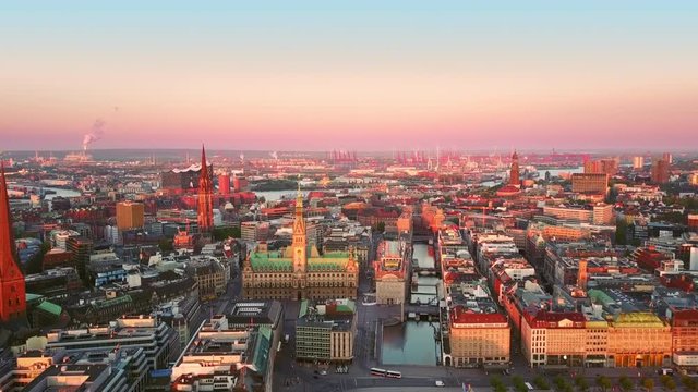 hamburg skyline aerial view at sunrise drone coming out from a window tilt down on town hall city center