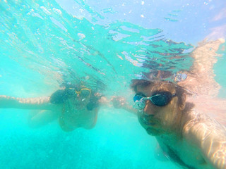 Obraz na płótnie Canvas Couple having fun underwater in the sea