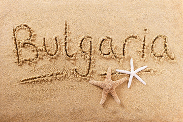 Bulgaria word written in sand sign writing drawing drawn on a sunny summer beach with starfish holiday vacation travel destination message photo