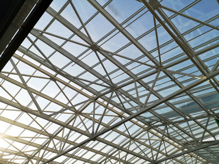 Glass roof shopping center or airport. Architecture and design of the roof in the style of high-tech. The sun shines skok glass © Siniehina