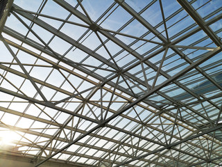 Glass roof shopping center or airport. Architecture and design of the roof in the style of high-tech. The sun shines skok glass