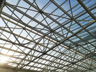 Glass roof shopping center or airport. Architecture and design of the roof in the style of high-tech. The sun shines skok glass © Siniehina