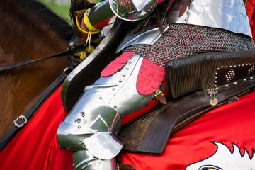 Close up of a medieval knight wering armour sitting on horseback