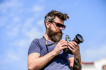 Content creator. Man bearded hipster photographer. Man shooting photos. Old but still good. Manual...