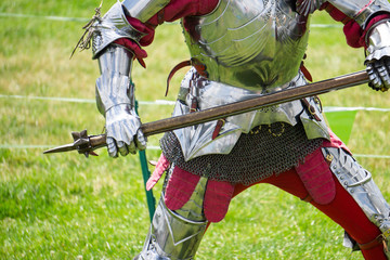 A medieval knight in amrour holding a weapon