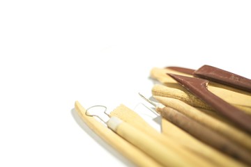 Pottery tools closeup isolated on white background, selective focus