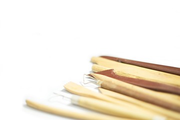 Pottery tools closeup isolated on white background, selective focus