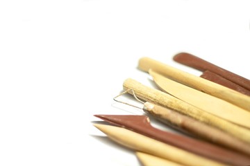 Pottery tools closeup isolated on white background, selective focus