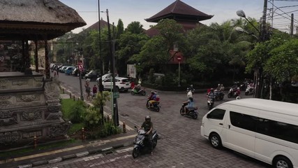 Aerial: Motorcycle traffic and tourists in town of Ubud, Bali. 20 March 2019