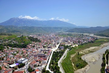 The albanian city of Berat, designated a UNESCO World Heritage Site in 2008. Top view from the Berat Castle to the city center and Tomorr Mountain  (Mount Tomorr) in the background. Albania