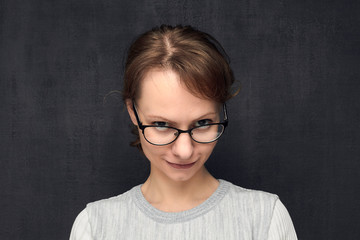 Fototapeta premium Portrait of cute and intrigued girl with eyeglasses