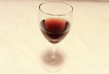  A glass of red wine on the marble table.