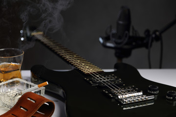Electric guitar, Studio microphone and whiskey with cigarette