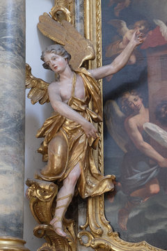 Angel statue on the St. Michael altar in the Neumunster Collegiate Church in Wurzburg, Germany