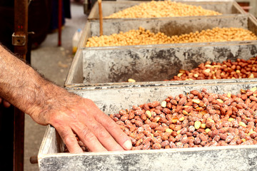 Man's hand takes nuts.