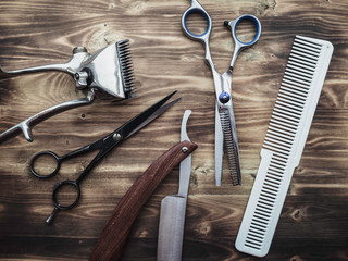 old rusty barber shop tools on wood background