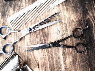 old rusty barber shop tools on wood background