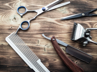 old rusty barber shop tools on wood background