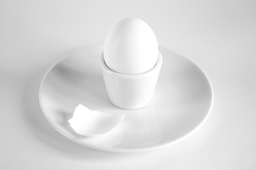 Black and white still life with whole egg and eggshell