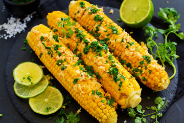 Boiled corn with mexican spices, butter, cilantro.