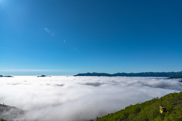 Panorama view from Unkai Terrace in summer time sunny day. Take the cable car at Tomamu Hoshino Resort, going up to see the sea of clouds. Shimukappu village, Hokkaido, Japan