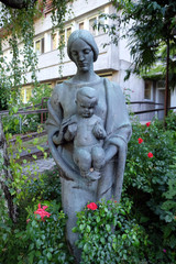 Fototapeta premium Virgin Mary with baby Jesus statue in the garden of the Blind Center Saint Raphael in Bolzano, Italy