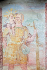 Naklejka premium Saint Christopher, fresco on the facade of Saint George church in Luson, Italy