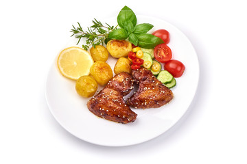 BBQ chicken wings with sesame seeds, spicy grilled meat with baked potatoes, close-up, isolated on white background