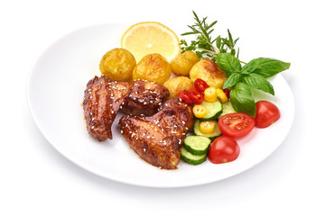 Tasty grilled chicken wings with baked potatoes, Restaurant food, close-up, isolated on white background