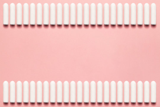 Unpacked tampons rectangle on a soft pink background. Modern female intimate gynecological hygiene. Eco zero waste concept. Copy space place for text. Flat lay