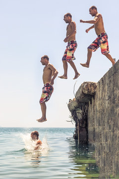 Man jumping from pier