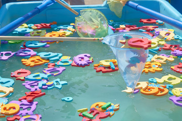 close up of floating colorful marine animal figures in the pool for catching a net. children's entertainment