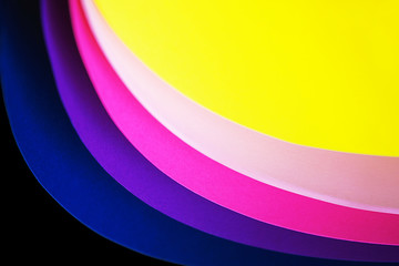 Trendy neon multicolor background from a arcs of cardboard different colors. Copy space. Back to school, party, celebration abstract concept. Minimal style.